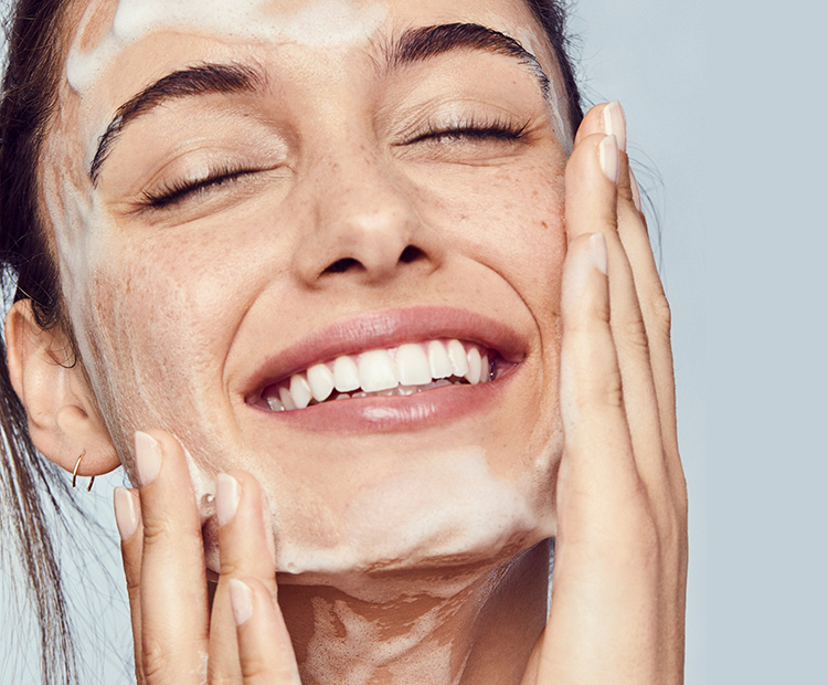 Woman washing face with skincare cleanser highlighting barrier-safe renewal Woman washing face with skincare cleanser highlighting barrier-safe renewal