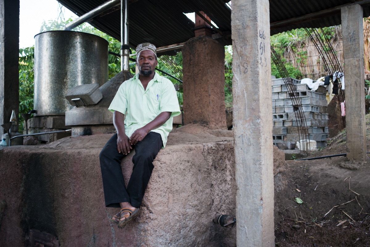 Comoros distillers harvesting ylang-ylang flowers and using energy-efficient stills for sustainable fragrance production