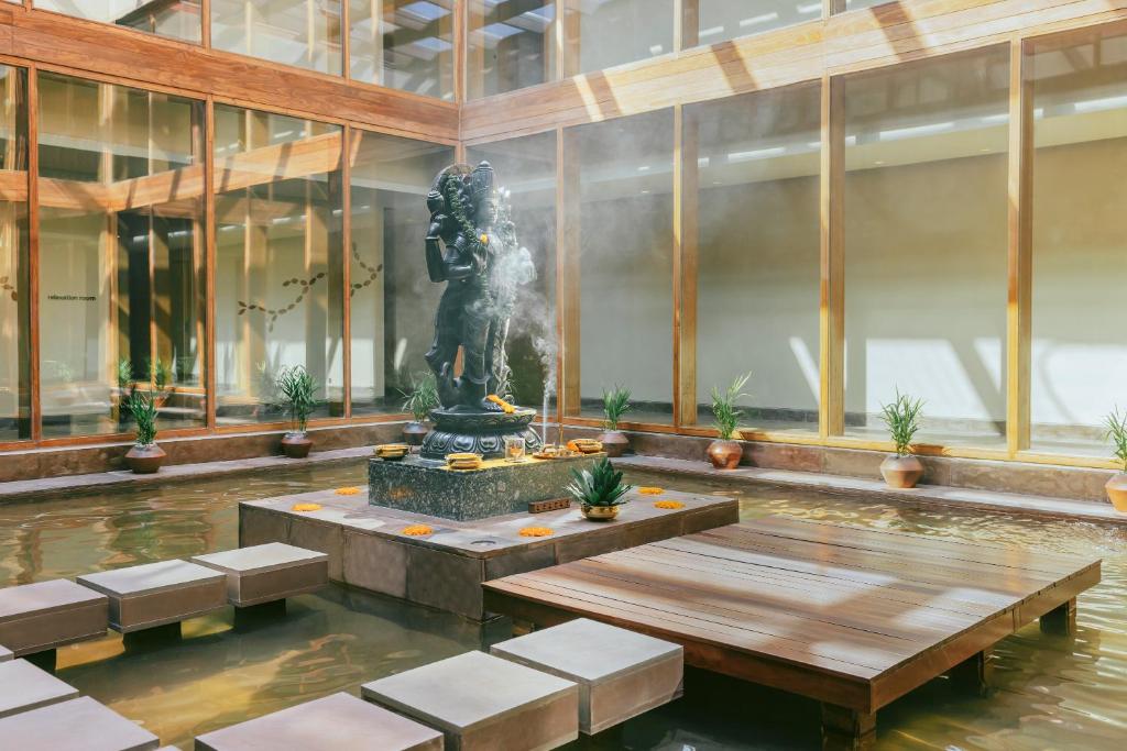 Artisan perfumer blending cedarwood and tulsi extracts. Vana retreat in Dehradun surrounded by Himalayan pine forests.