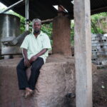 Comoros distillers harvesting ylang-ylang flowers and using energy-efficient stills for sustainable fragrance production